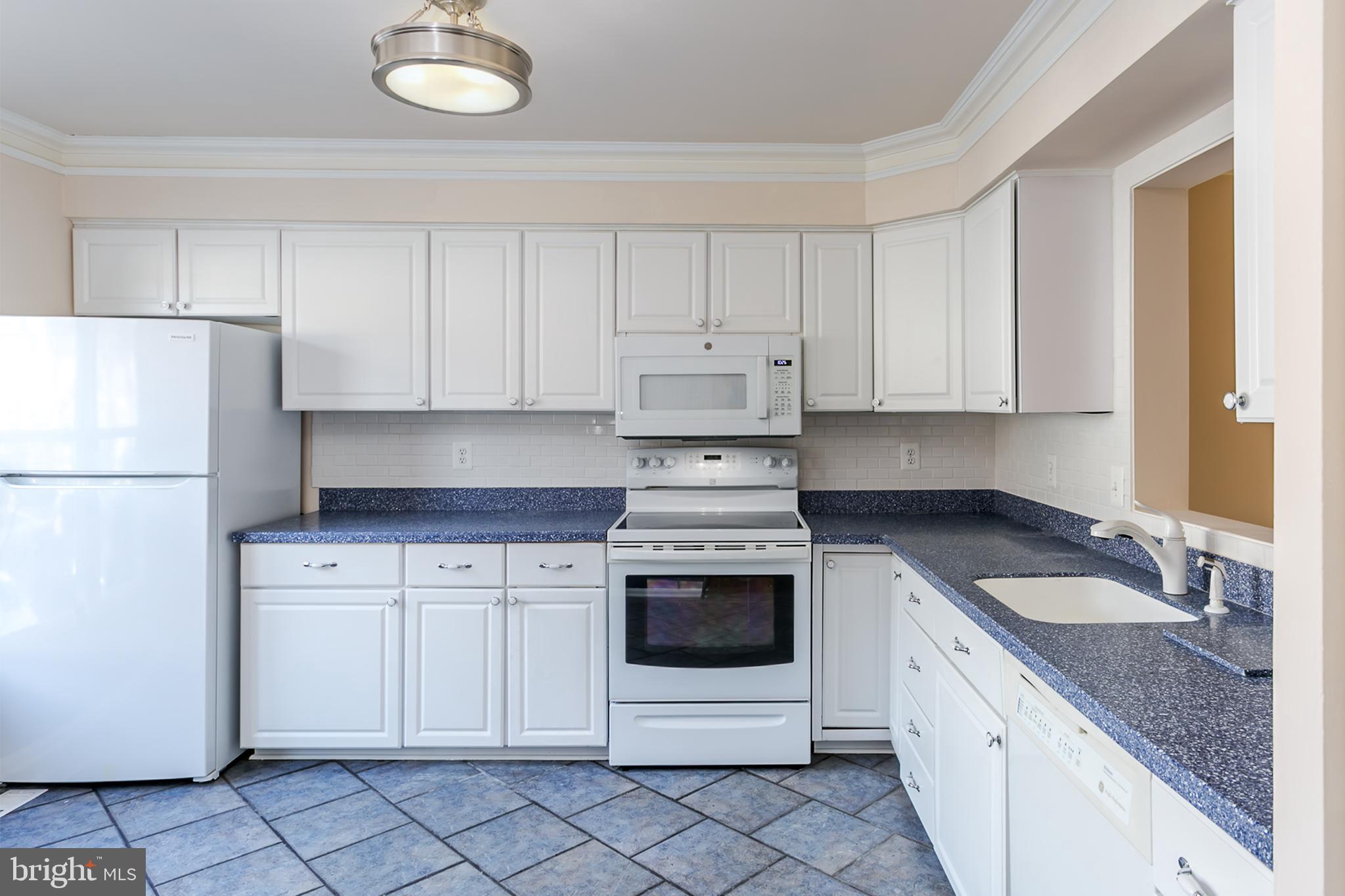33 Kinsman View Circle Silver Spring, MD 20901 - Photo 3 of 26 a kitchen with granite countertop white cabinets and white appliances