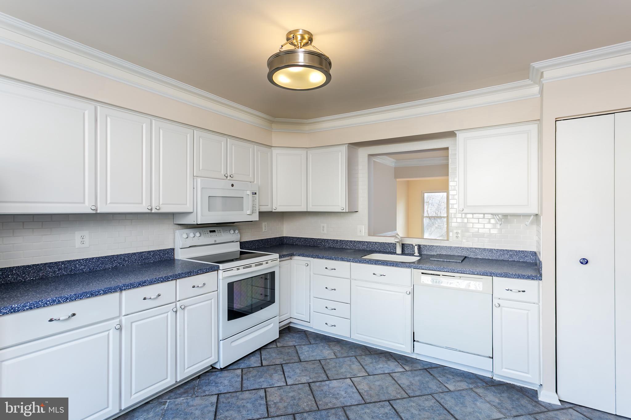 33 Kinsman View Circle Silver Spring, MD 20901 - Photo 4 of 26 a kitchen with granite countertop white cabinets white stainless steel appliances with a sink and dishwasher