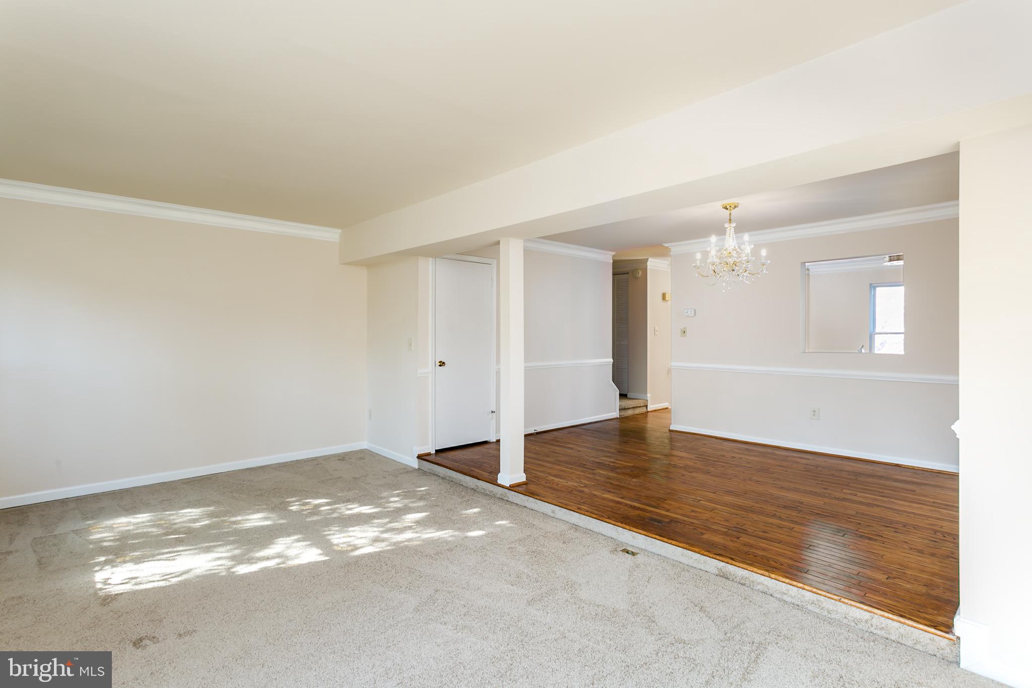 33 Kinsman View Circle Silver Spring, MD 20901 - Photo 8 of 26 an empty room with wooden floor and windows