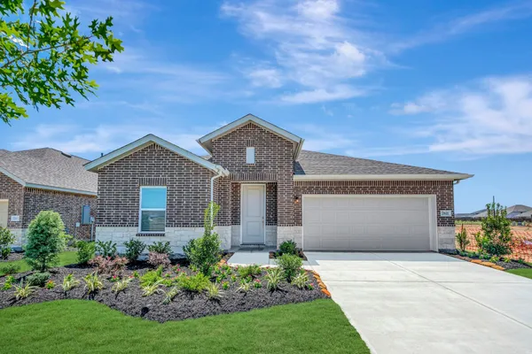 a front view of house with a garden