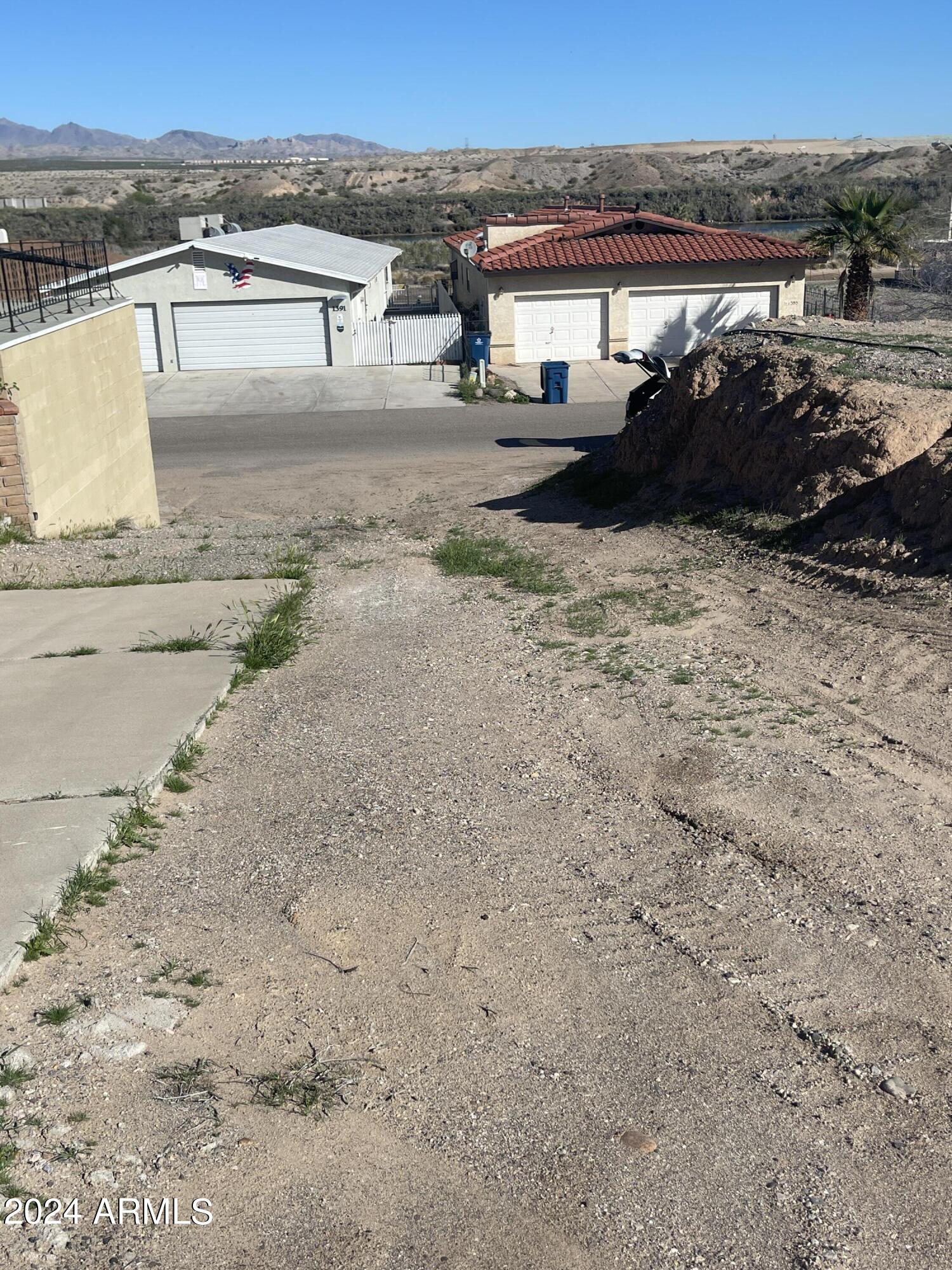 1394 Riverfront Drive, Unit 66 Bullhead City, AZ 86442 - Photo 7 of 11 a view of a house with a yard and ocean view