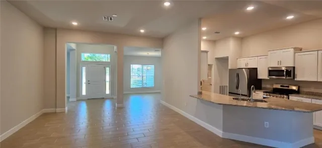 a view of kitchen with cabinets and wooden floor