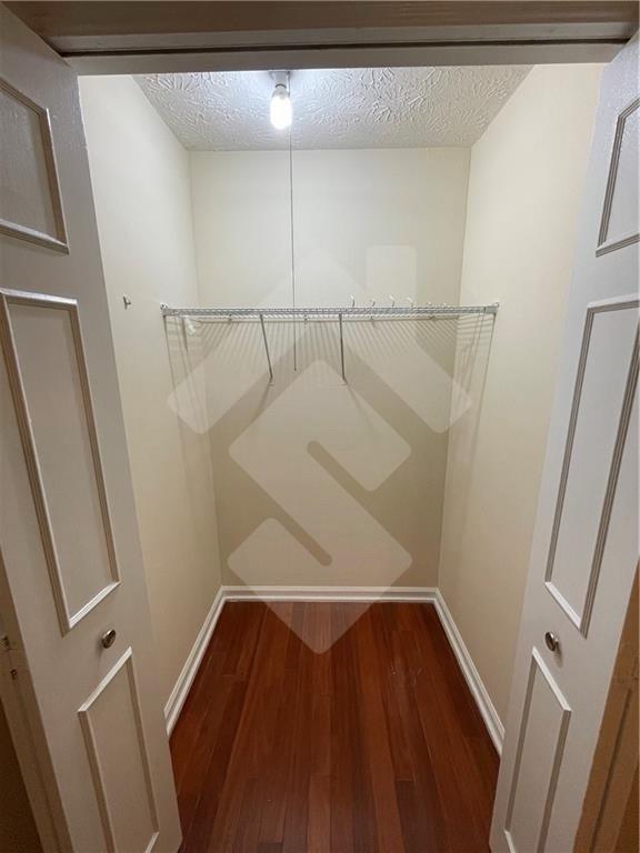 4267 Grogan Street Acworth, GA 30101 - Photo 29 of 37 a view of walk in closet with wooden floor