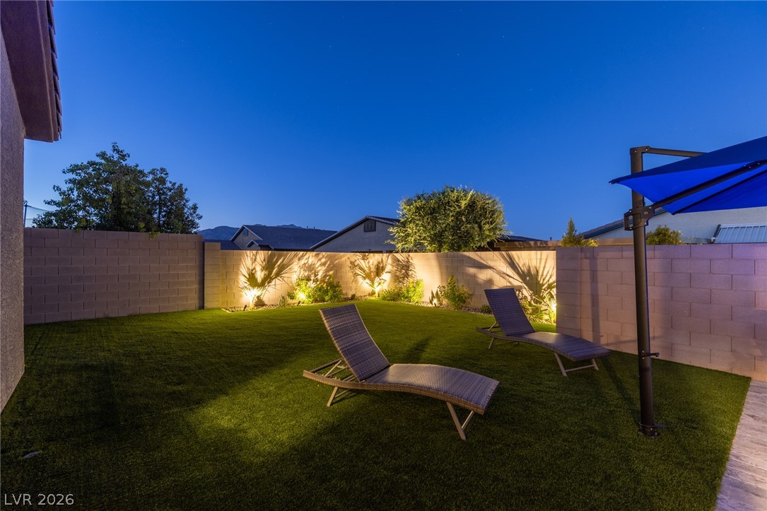 7036 Arabian Ridge Street Las Vegas, NV 89131 - Photo 59 of 64 Low maintenance landscaping and lighting with plenty of space.