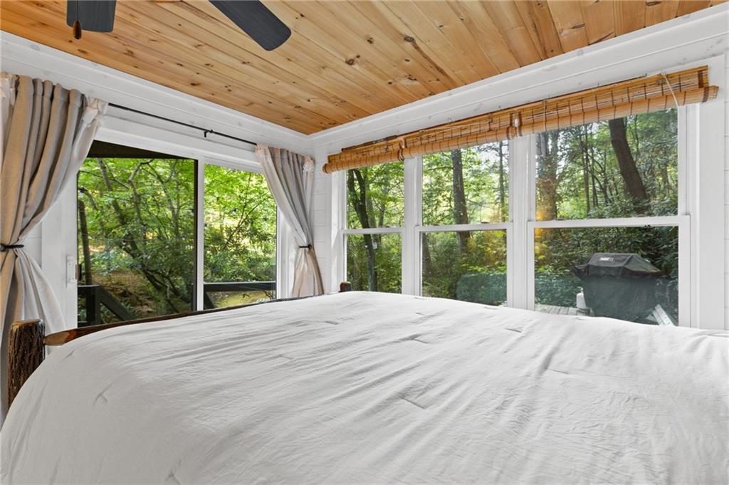129 Old Bend Road Blue Ridge, GA 30513 - Photo 14 of 44 a large bed in a large room with a large window