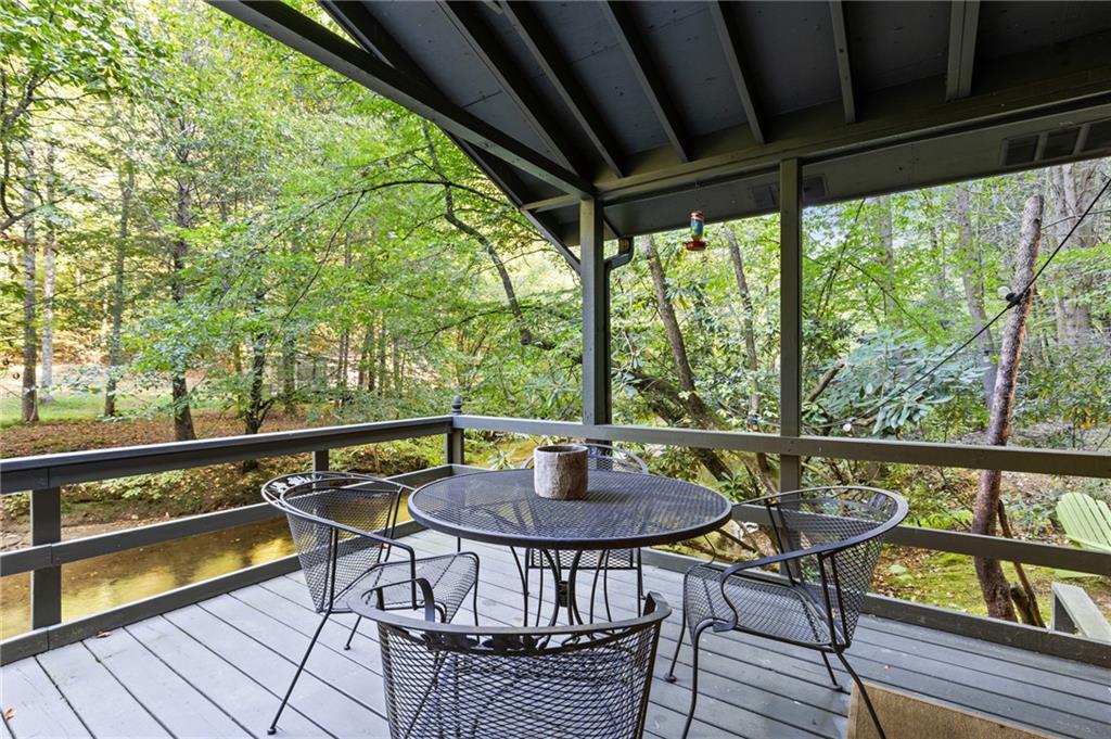 129 Old Bend Road Blue Ridge, GA 30513 - Photo 28 of 44 a view of a chairs and table in patio with wooden floor