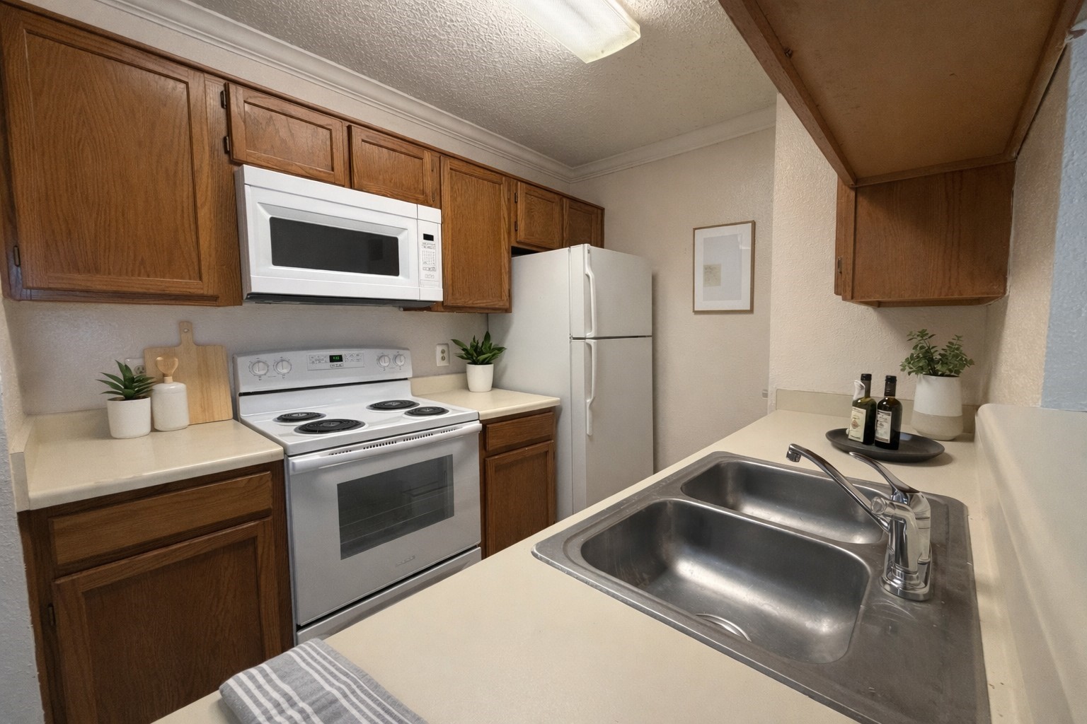 2121 Hepburn Street, Unit 1110 Houston, TX 77054 - Photo 6 of 22 This virtually staged kitchen boasts a fresh look with a brand-new stove and microwave, perfect for modern living.