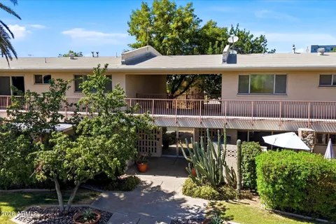 a view of a house with garden and sitting area