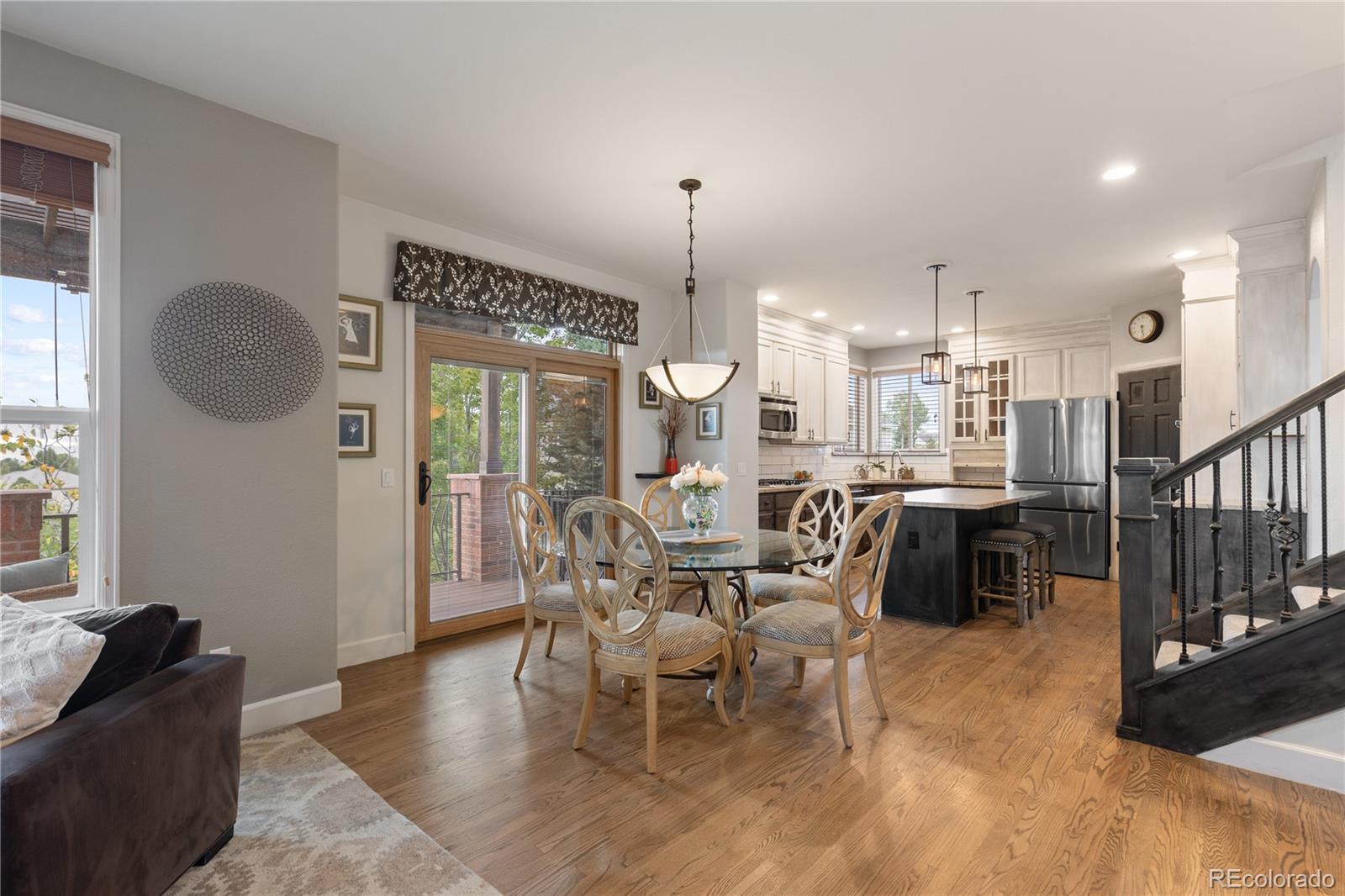 6261 South Sicily Way Aurora, CO 80016 - Photo 16 of 50 a dining room with furniture a chandelier and wooden floor