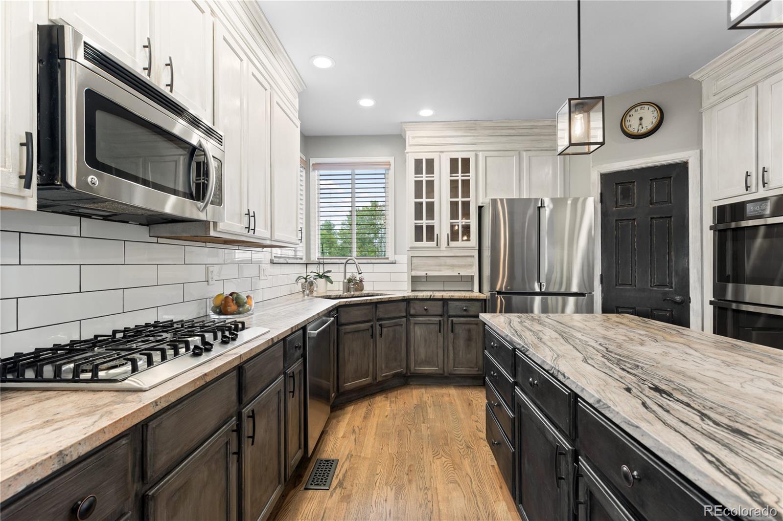 6261 South Sicily Way Aurora, CO 80016 - Photo 20 of 50 a kitchen with stainless steel appliances a sink stove and refrigerator