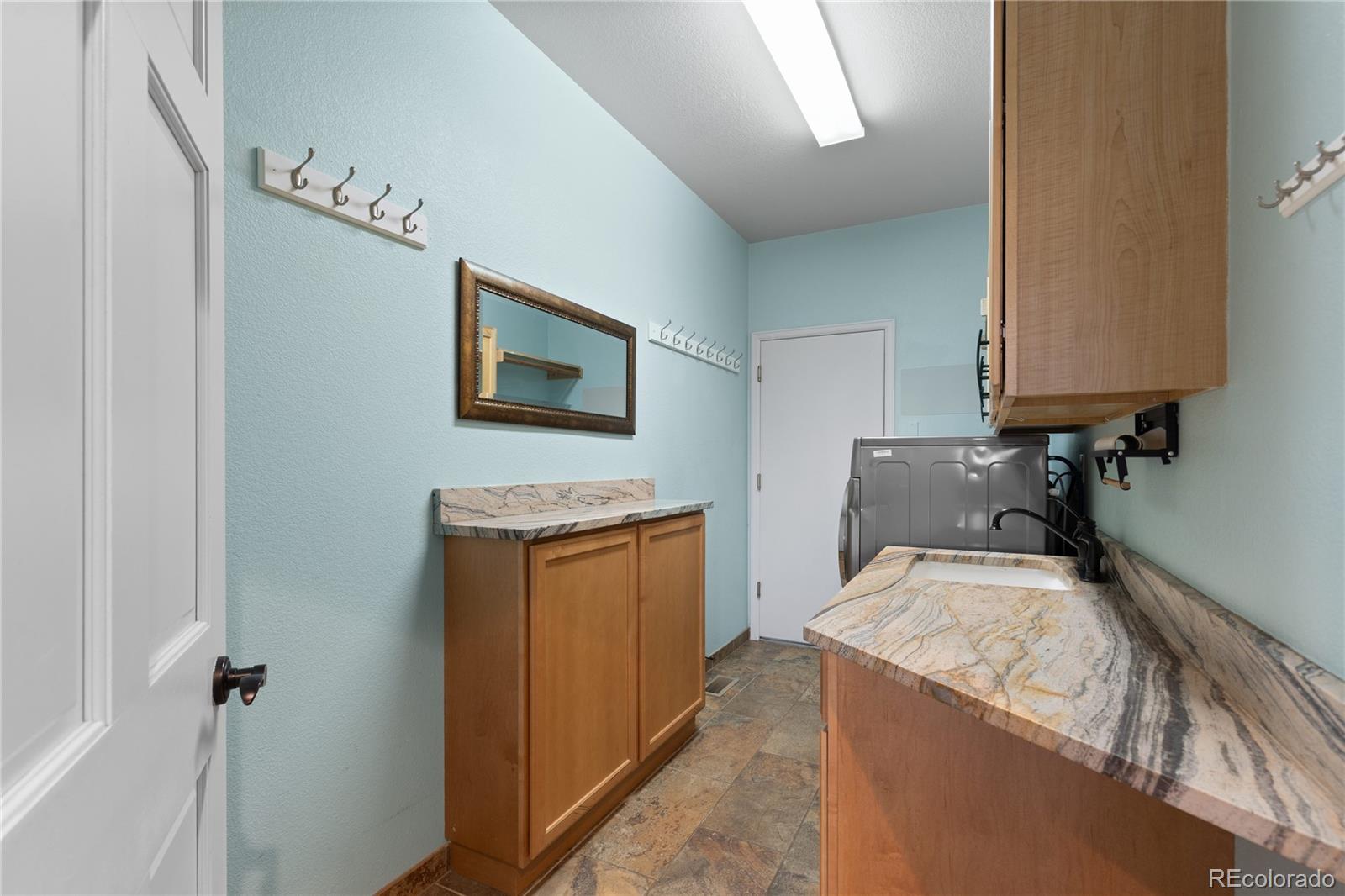 6261 South Sicily Way Aurora, CO 80016 - Photo 24 of 50 a utility room with a sink a washer and dryer