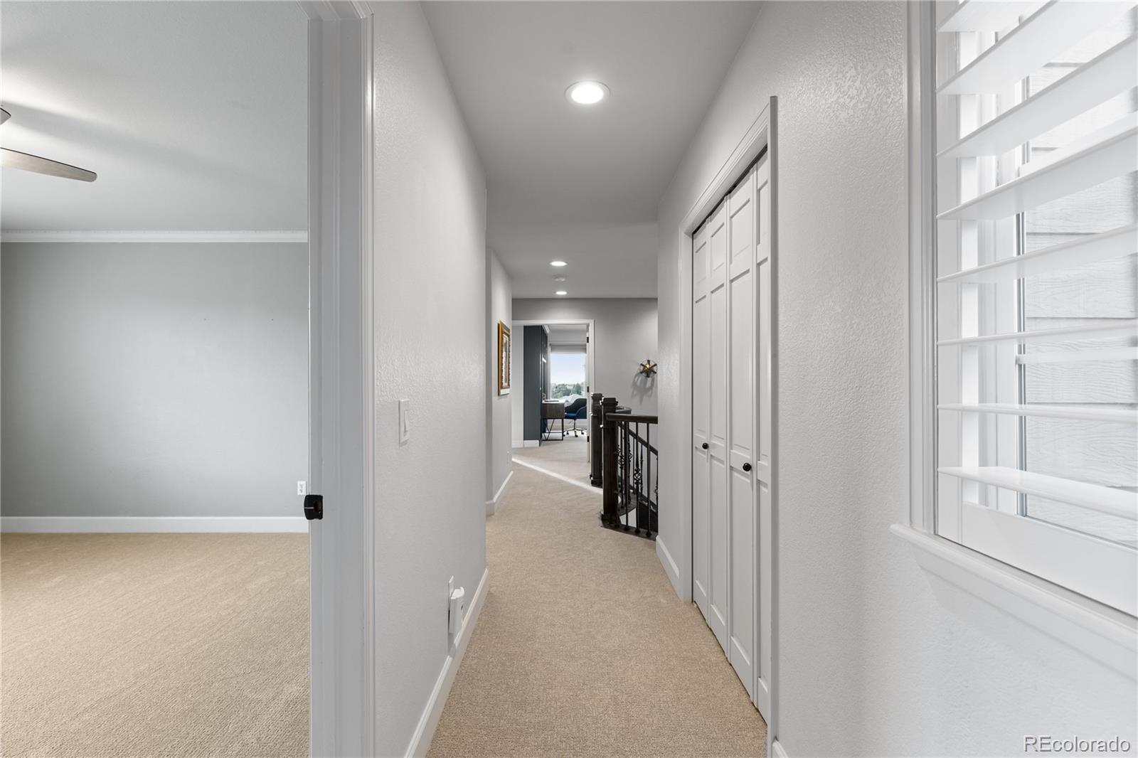 6261 South Sicily Way Aurora, CO 80016 - Photo 35 of 50 a view of a hallway with a livingroom and a bathroom
