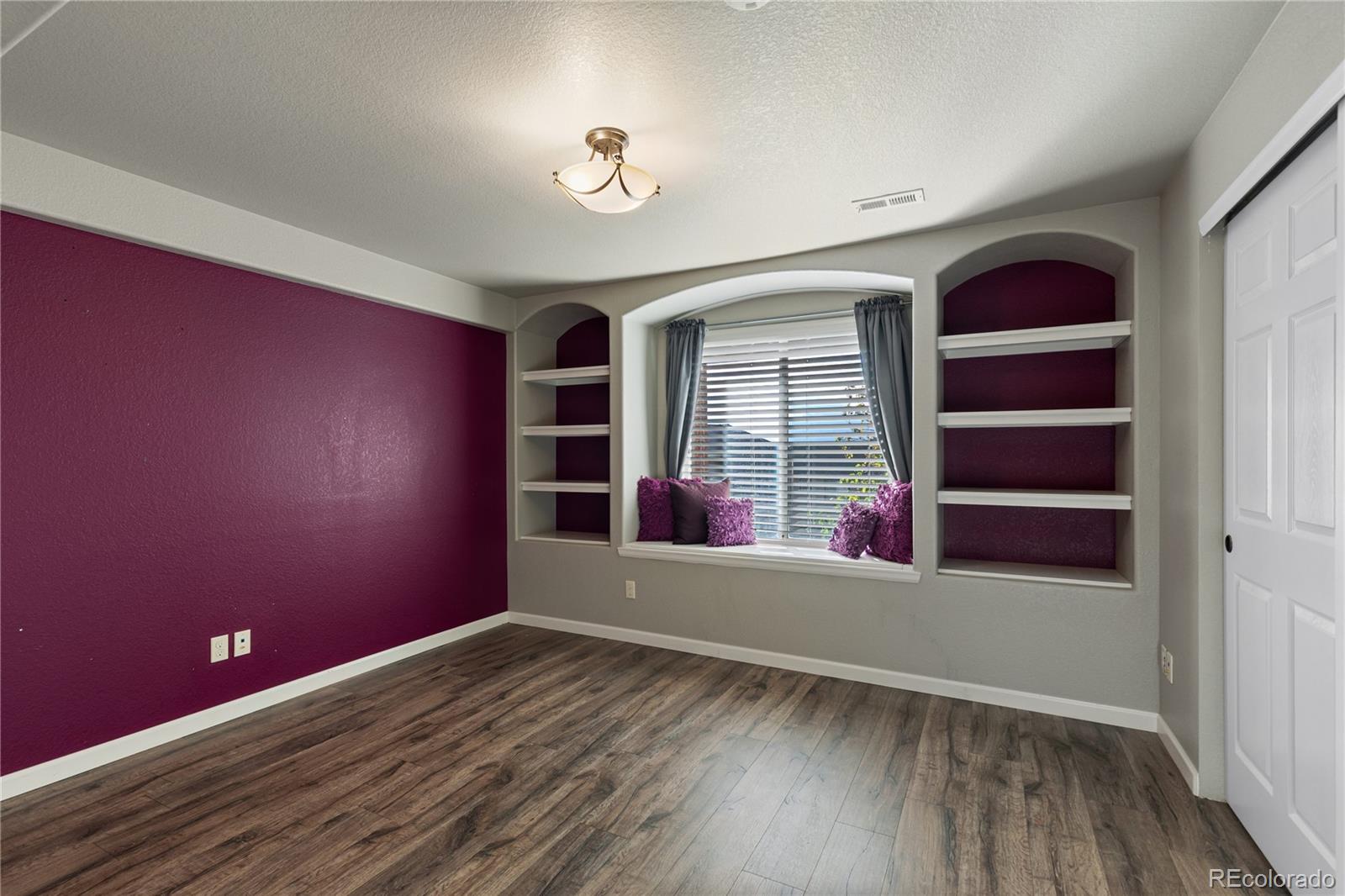 6261 South Sicily Way Aurora, CO 80016 - Photo 43 of 50 wooden floor in an empty room with a window
