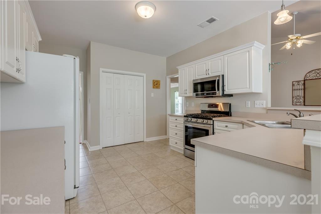 305 Savannah Lane Fort Mill, SC 29708 - Photo 13 of 46 a kitchen with a sink a stove top oven and refrigerator