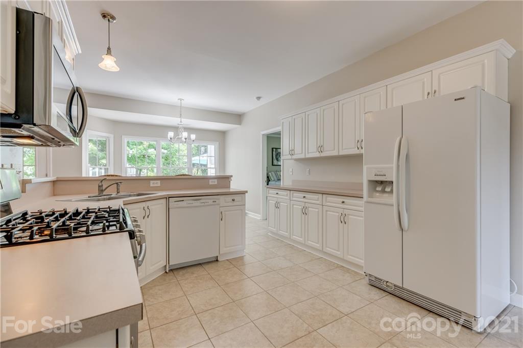 305 Savannah Lane Fort Mill, SC 29708 - Photo 14 of 46 a kitchen with white cabinets and white appliances
