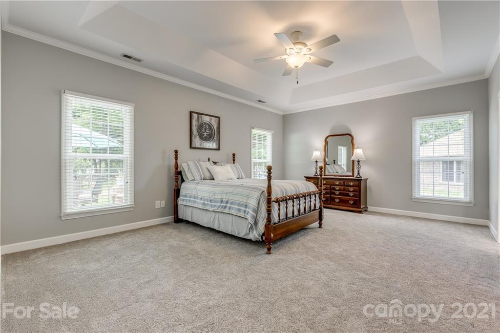 305 Savannah Lane Fort Mill, SC 29708 - Photo 20 of 46 a bedroom with a bed chandelier and a window