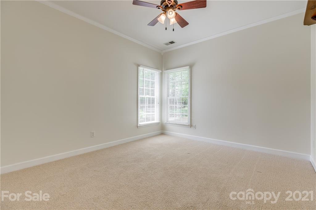 305 Savannah Lane Fort Mill, SC 29708 - Photo 29 of 46 en empty room with windows and chandelier fan