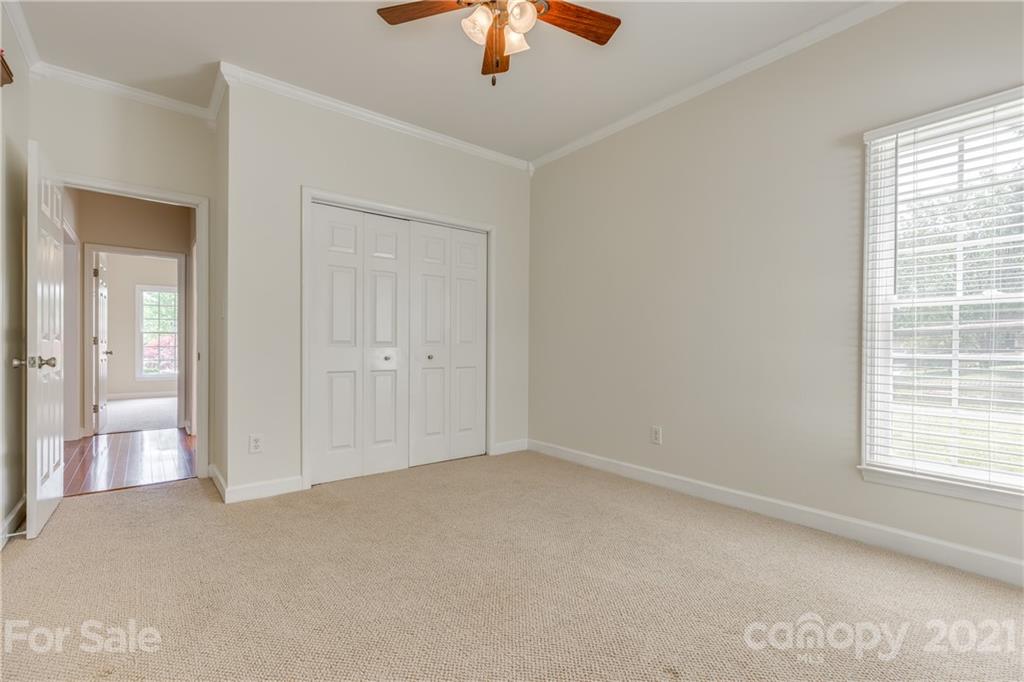 305 Savannah Lane Fort Mill, SC 29708 - Photo 30 of 46 an empty room with chandelier fan and windows