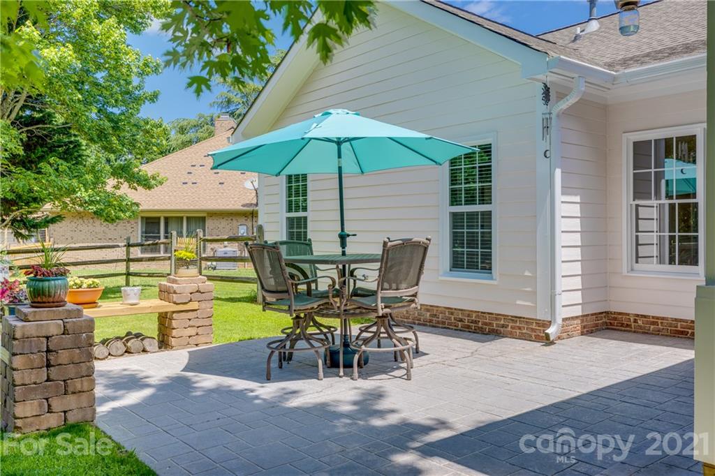 305 Savannah Lane Fort Mill, SC 29708 - Photo 40 of 46 a view of a patio with table and chairs under an umbrella