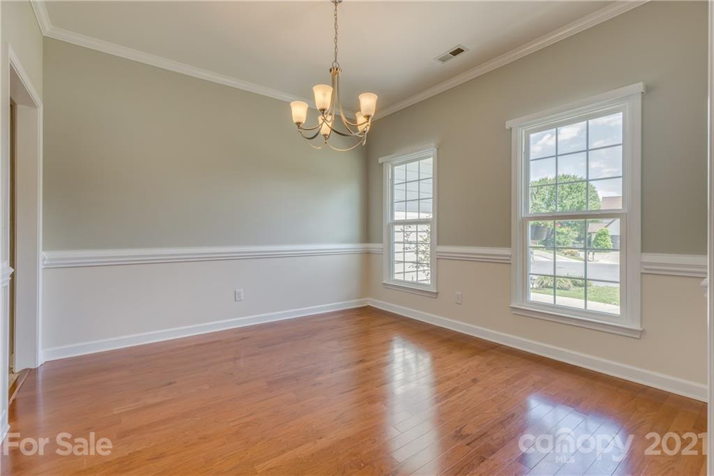 305 Savannah Lane Fort Mill, SC 29708 - Photo 7 of 46 an empty room with wooden floor and windows