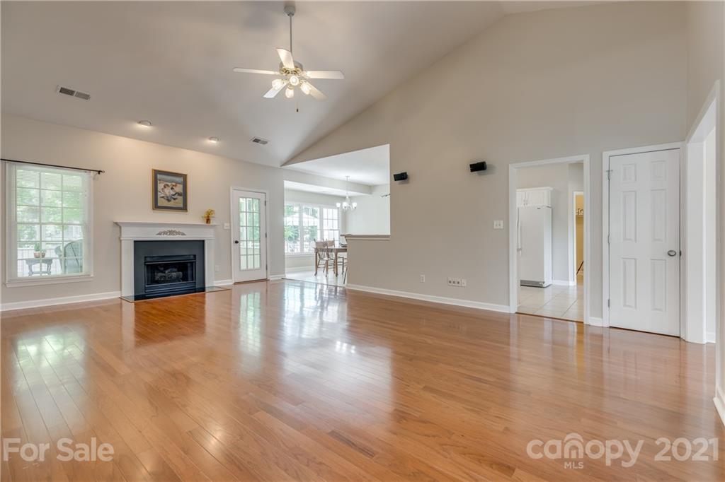 305 Savannah Lane Fort Mill, SC 29708 - Photo 10 of 46 a view of a livingroom with a ceiling fan a fireplace and wooden floor