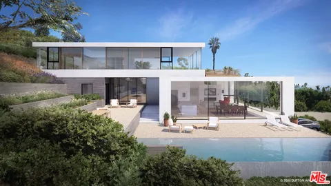 a building view with couches and table and chairs under an umbrella