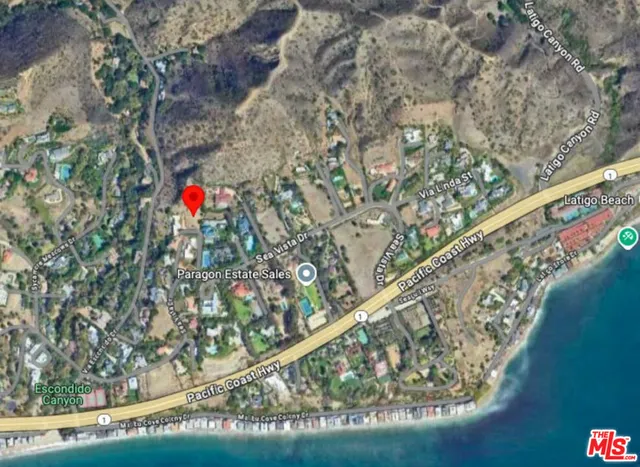 an aerial view of a house with yard and mountain view in back