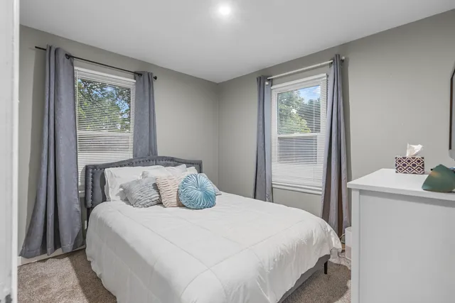 a bedroom with a large bed and a window