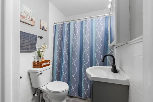 a bathroom with a sink a toilet and a mirror