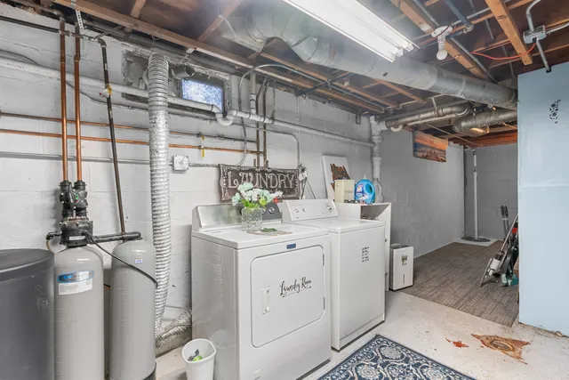 a utility room with cabinets washer and dryer