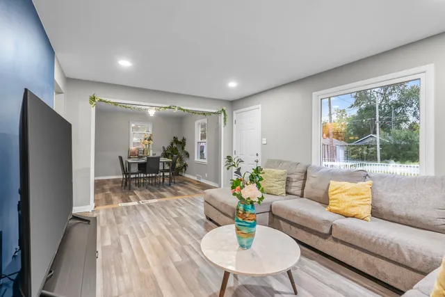 a living room with furniture and wooden floor