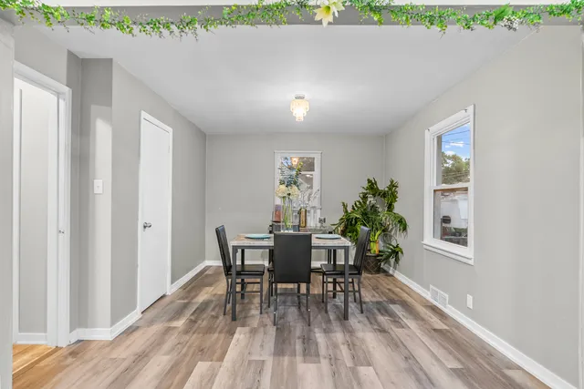 a view of a dining room with furniture and wooden floor