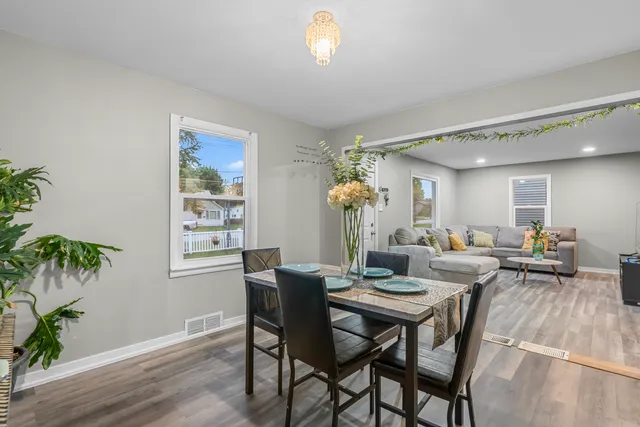 a view of a dining room with furniture and wooden floor