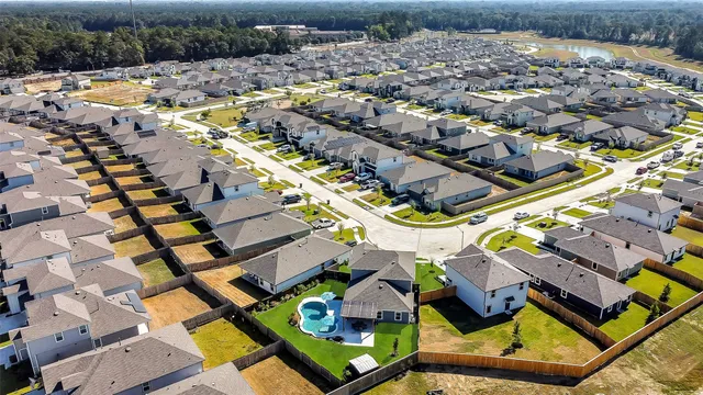 an aerial view of residential houses with yard