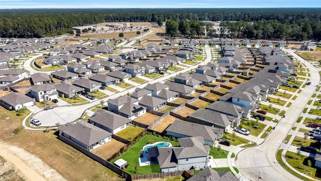 an aerial view of multiple houses with yard