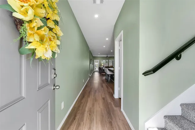 a view of entryway and hall with wooden floor