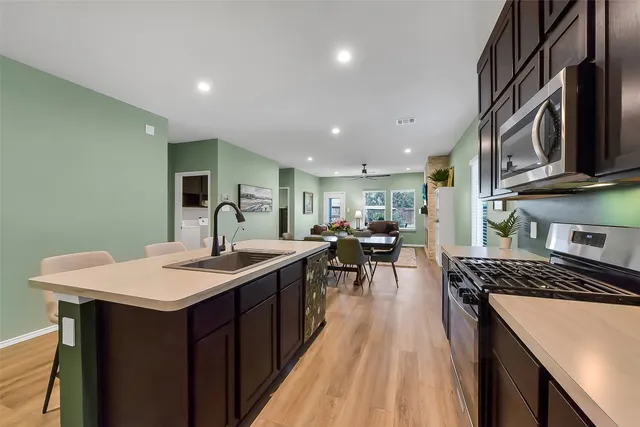 a kitchen with sink stove and cabinets