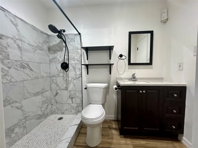 a bathroom with a sink toilet and shower