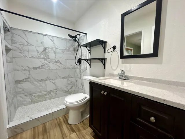 a bathroom with a sink toilet and shower