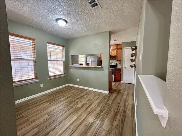 a view of a room with wooden floor and windows