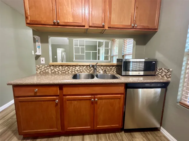 a kitchen with stainless steel appliances granite countertop a sink and cabinets