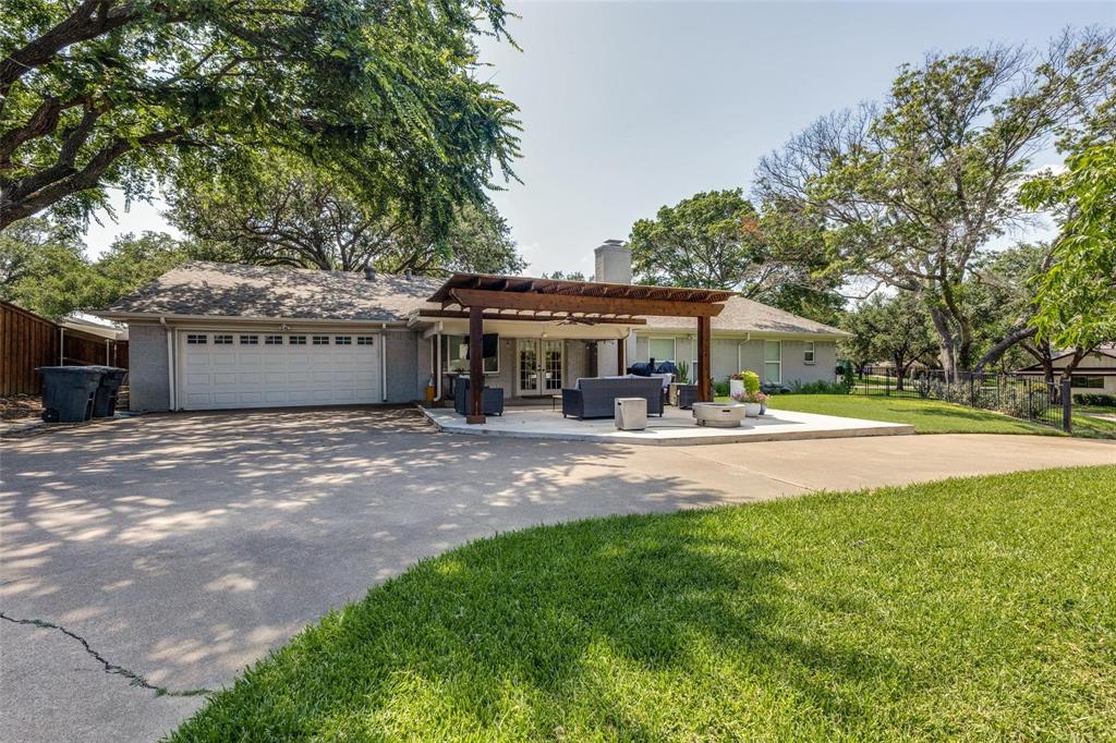4301 Winding Way Benbrook, TX 76126 - Photo 24 of 25 View of front facade featuring a chimney, driveway, a garage, outdoor lounge area, and brick siding