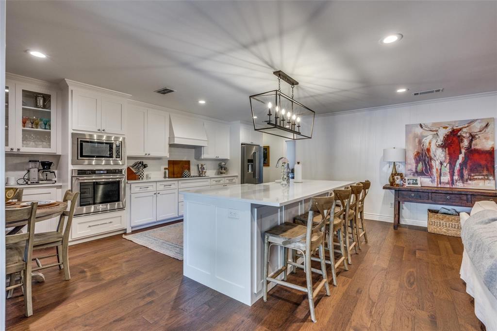 4301 Winding Way Benbrook, TX 76126 - Photo 9 of 25 Kitchen featuring pendant lighting, appliances with stainless steel finishes, dark wood-type flooring, a breakfast bar area, and recessed lighting