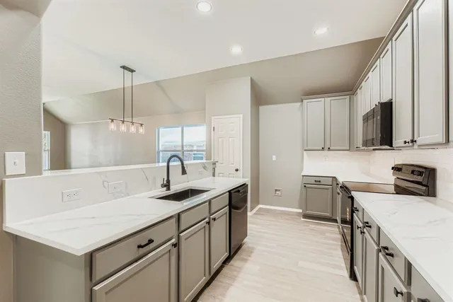 a kitchen with a sink stove and cabinets