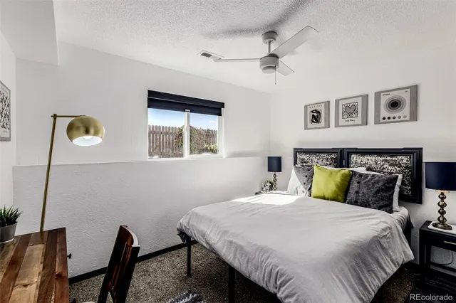 a bedroom with a large bed and a window