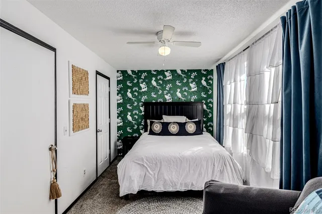 a bedroom with a bed couch and window