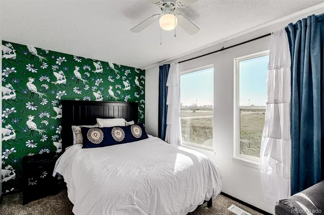 a bedroom with a large bed and a large window