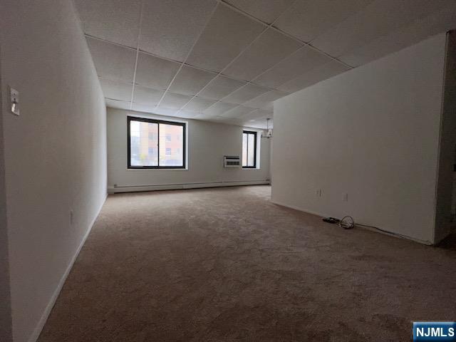 77 Prospect Avenue, Unit 1A Hackensack, NJ 07601 - Photo 3 of 16 an empty room with windows