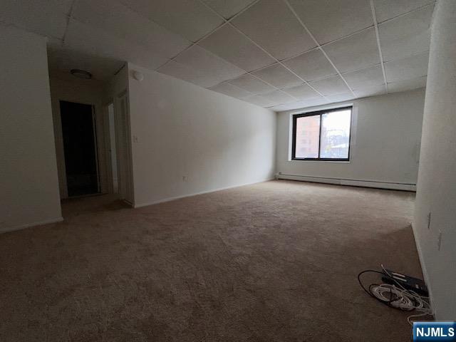 77 Prospect Avenue, Unit 1A Hackensack, NJ 07601 - Photo 4 of 16 an empty room with windows
