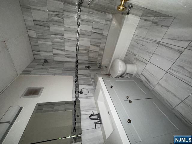 77 Prospect Avenue, Unit 1A Hackensack, NJ 07601 - Photo 5 of 16 a bathroom with a sink a toilet and shower